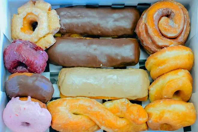 An open box packed with an assortment of hand-made Doughboys donuts