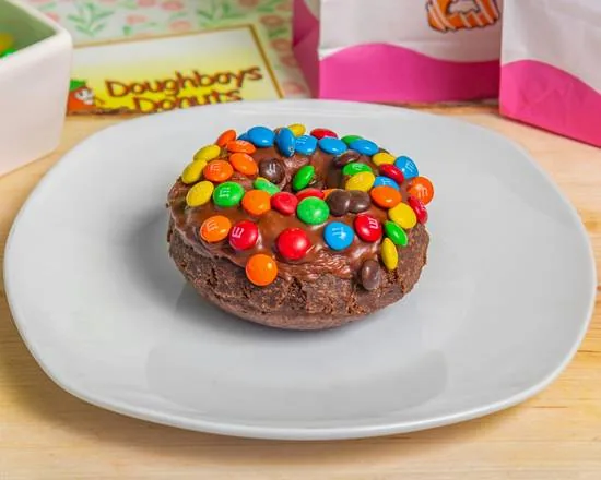 A Devil's Food cake donut iced with chocolate and topped with candies